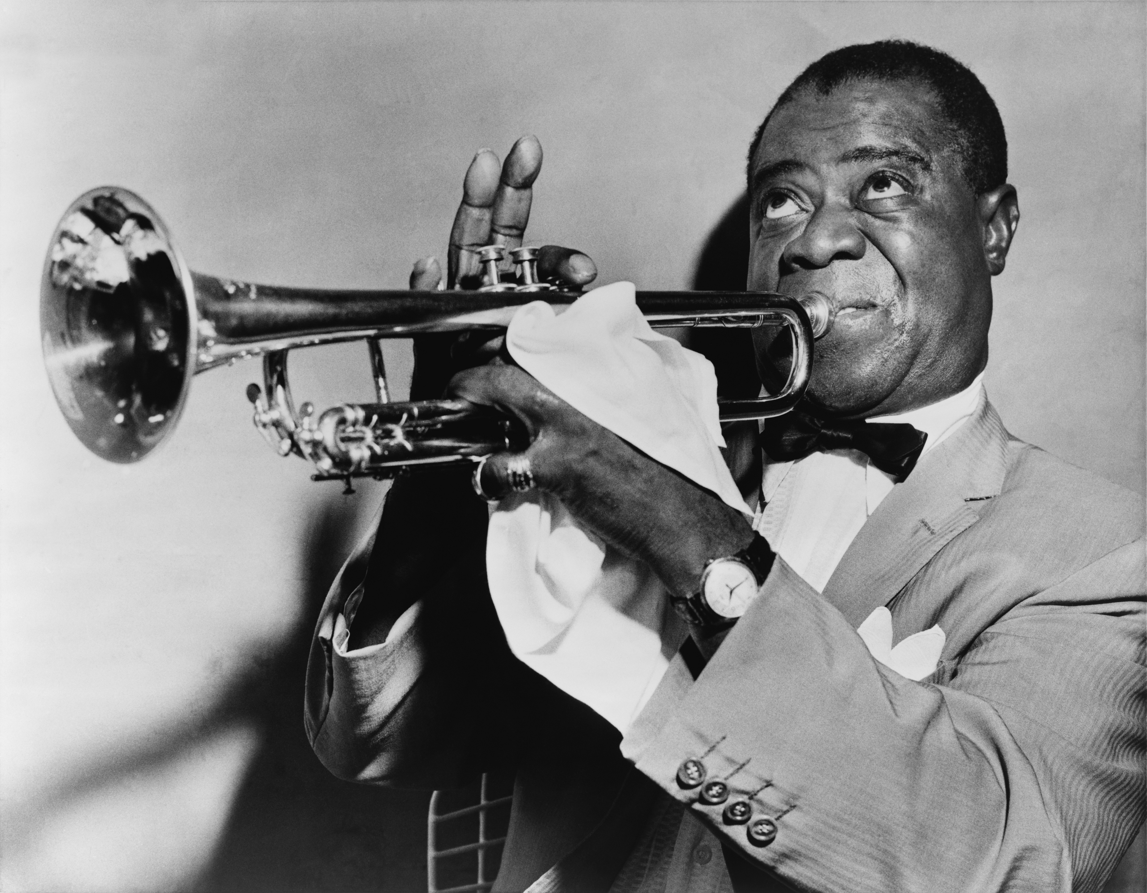 Louis Armstrong playing trumpet during a performance in 1953.